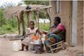 ESDS Uganda Cooking Stove in front of a House.JPG